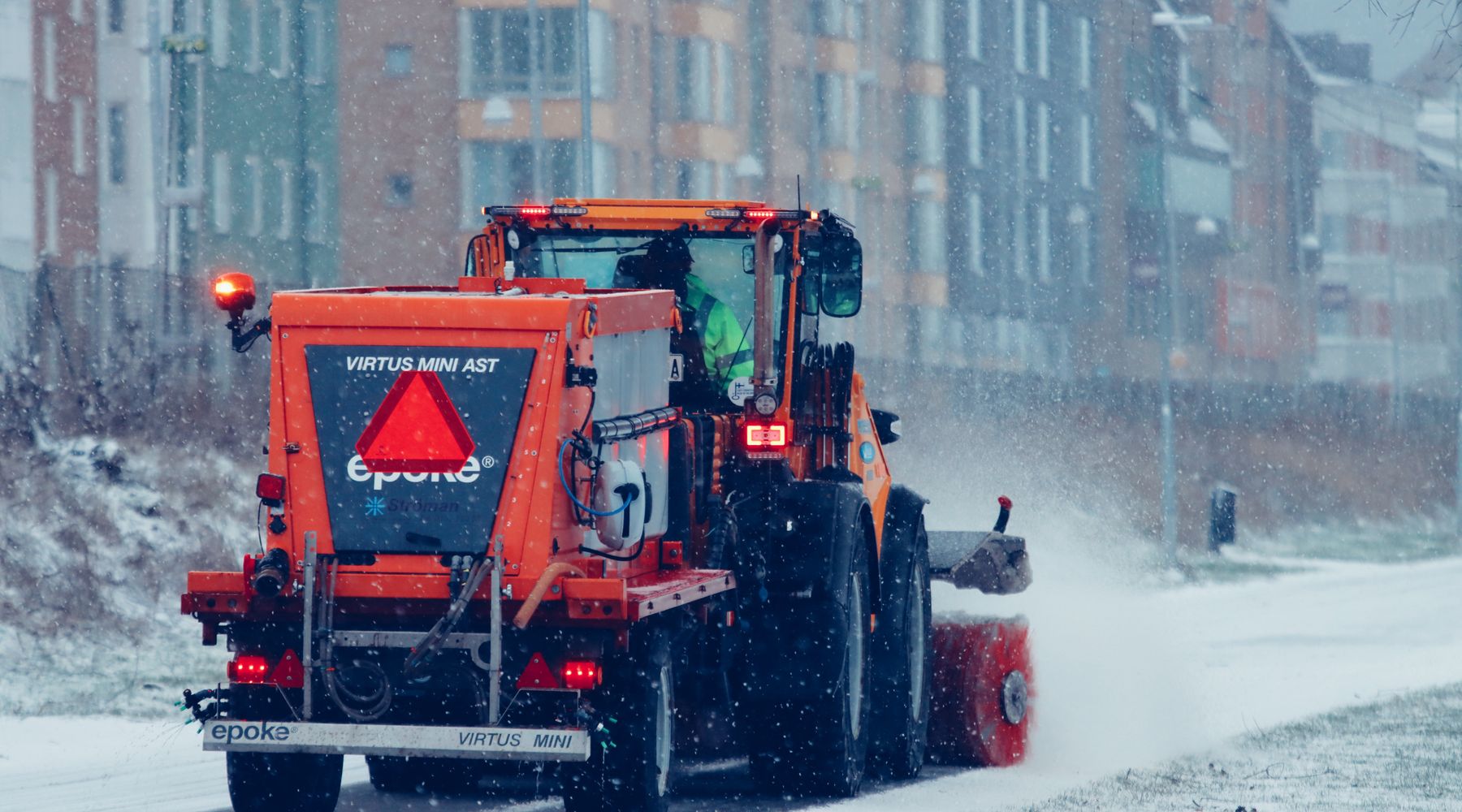 Close up of steel plow blade throwing winter snow